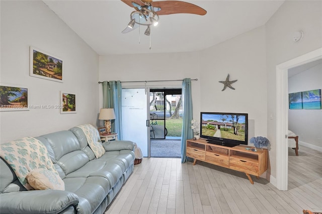 living room with baseboards, ceiling fan, and light wood finished floors