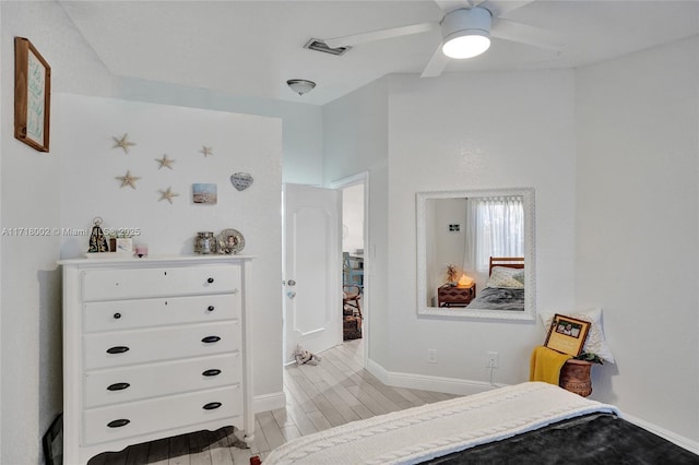 bedroom with a ceiling fan, light wood-style flooring, visible vents, and baseboards