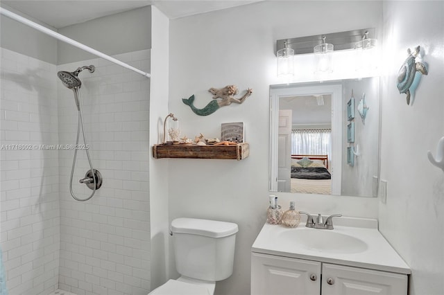 ensuite bathroom with a tile shower, vanity, toilet, and ensuite bathroom