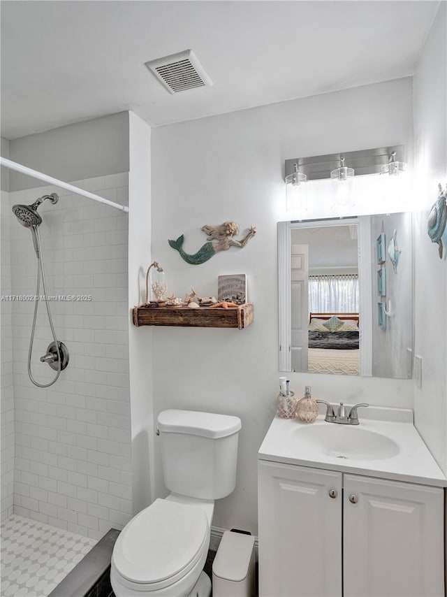 full bathroom with ensuite bathroom, toilet, vanity, visible vents, and a stall shower