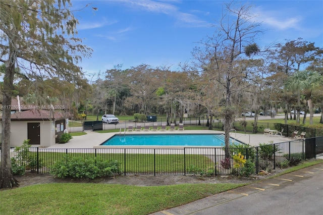 pool with fence, a lawn, and a patio