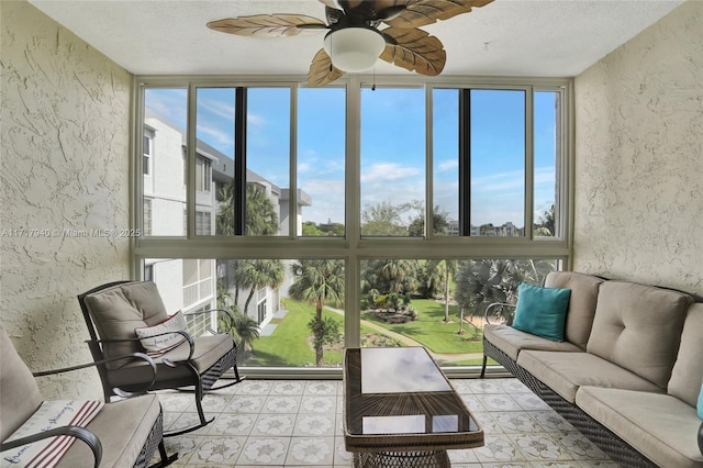 sunroom / solarium featuring ceiling fan and a healthy amount of sunlight