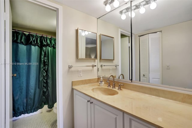 bathroom with tile patterned floors, vanity, and toilet