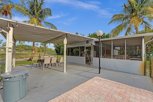 view of patio with a sunroom