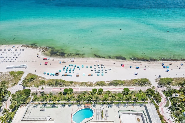 drone / aerial view featuring a water view and a beach view