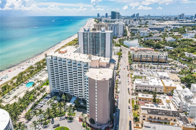 birds eye view of property with a water view and a view of the beach