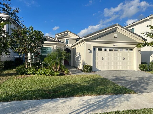 view of front of house featuring a garage and a front lawn