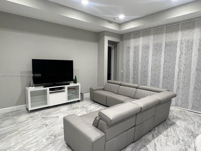 living room featuring a raised ceiling