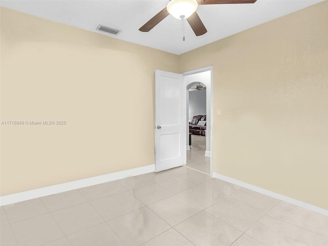 empty room with light tile patterned floors and ceiling fan