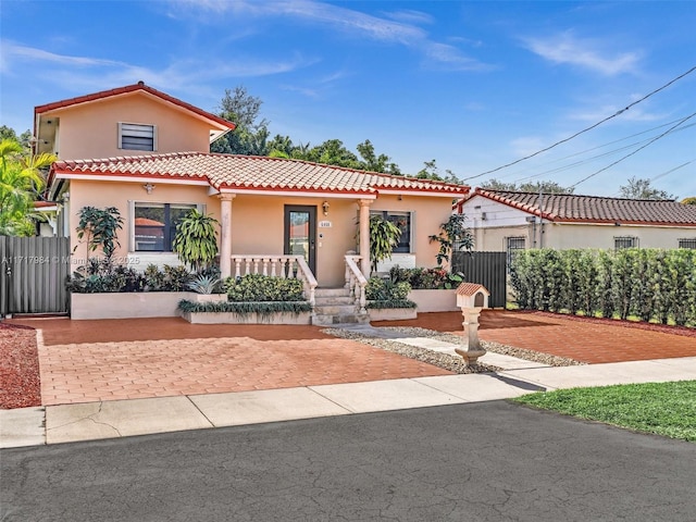 mediterranean / spanish house with covered porch