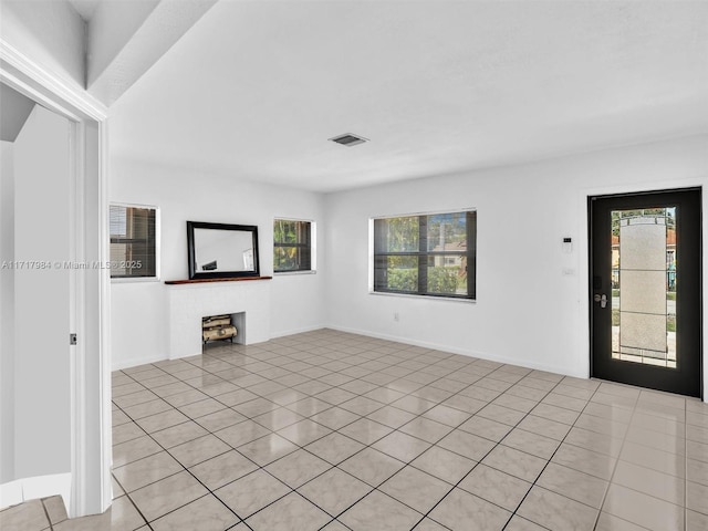 unfurnished living room featuring light tile patterned floors