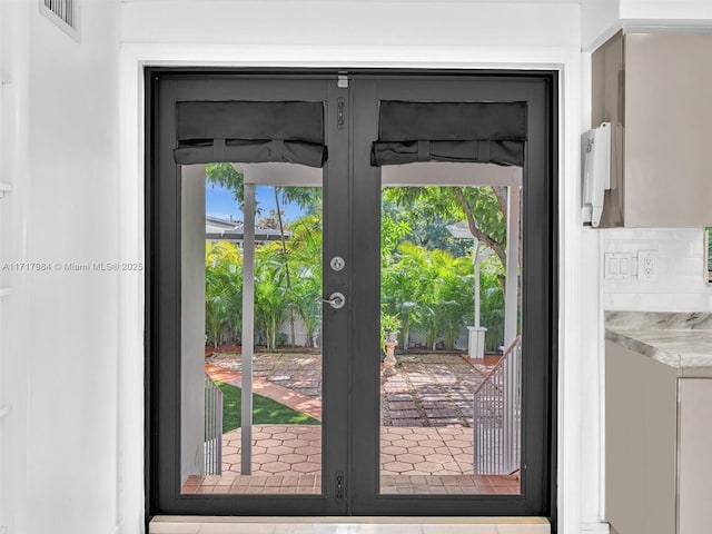 entryway with plenty of natural light and french doors