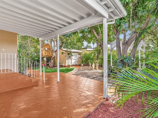 view of patio with a storage unit