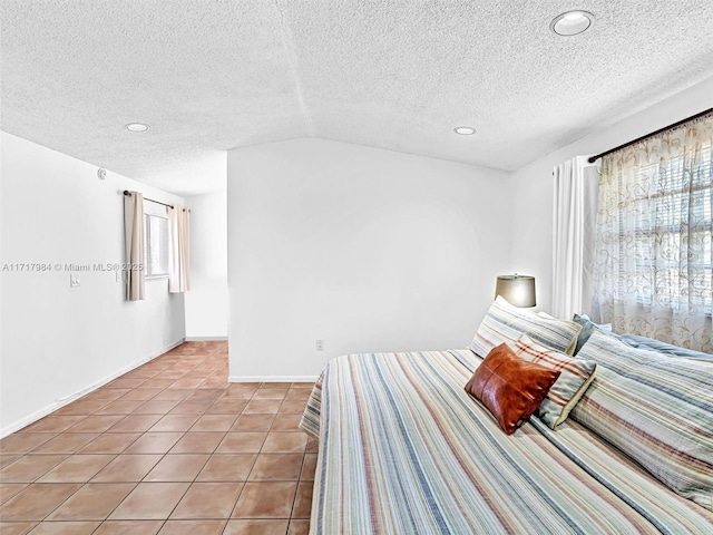 unfurnished bedroom featuring lofted ceiling, a textured ceiling, and light tile patterned floors