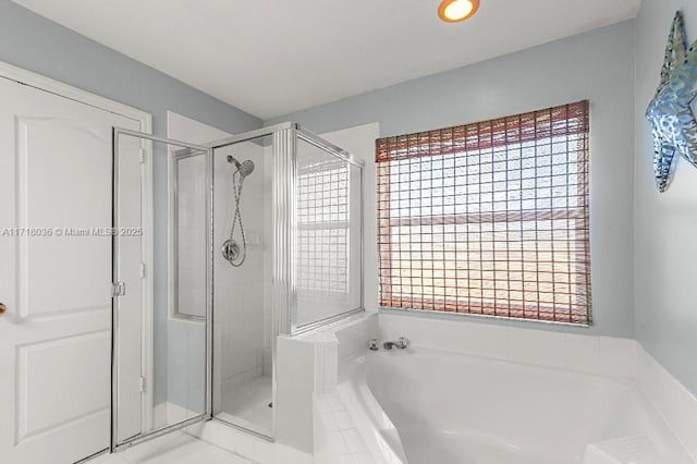 bathroom featuring plenty of natural light and plus walk in shower