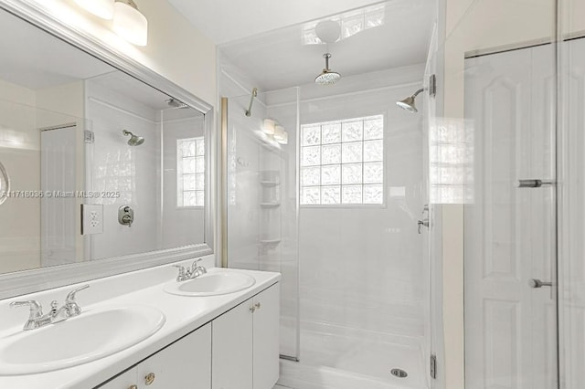 bathroom featuring vanity and a shower with door