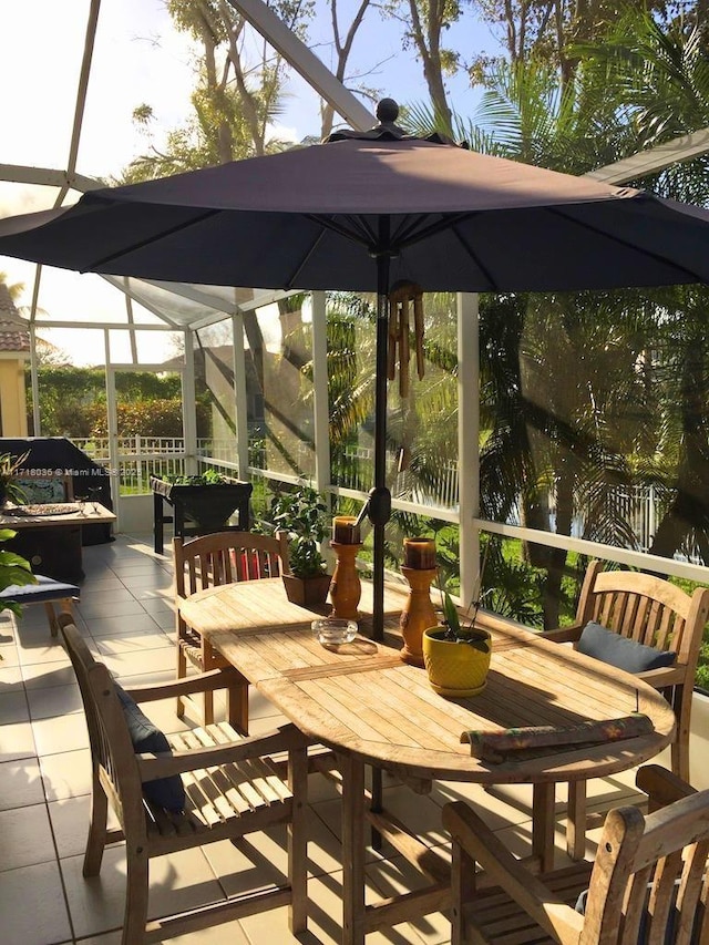 view of patio featuring a lanai