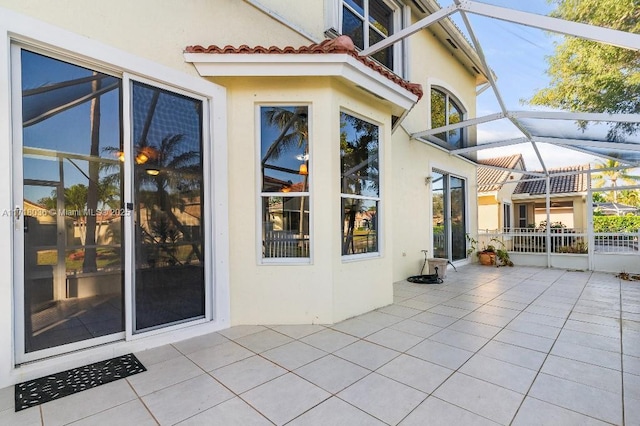 view of patio / terrace featuring glass enclosure