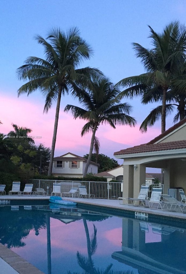 view of pool at dusk