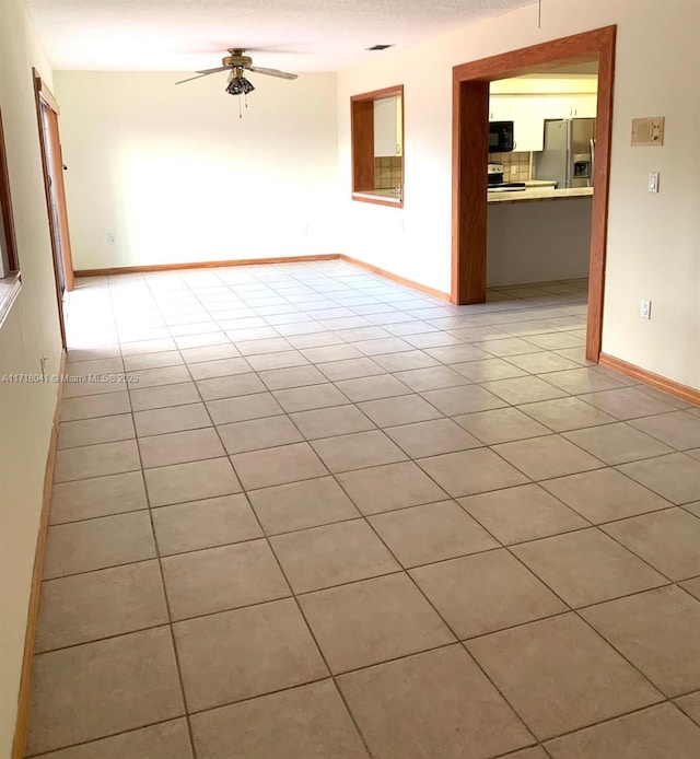 tiled empty room with ceiling fan