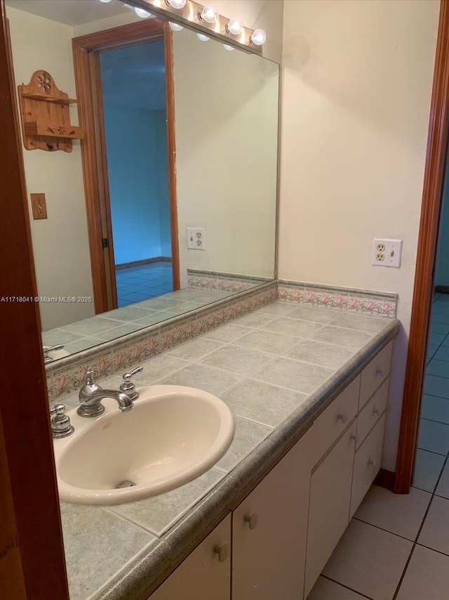 bathroom with tile patterned floors and vanity