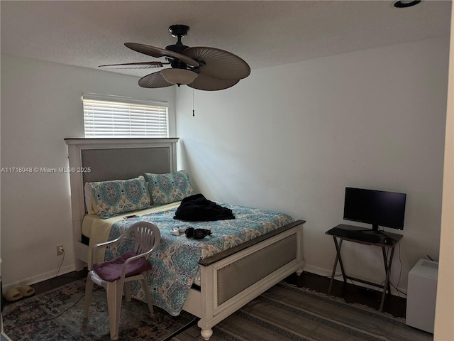 bedroom featuring dark hardwood / wood-style floors and ceiling fan