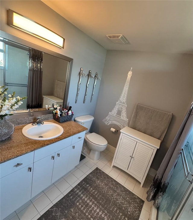 bathroom featuring tile patterned flooring, vanity, and toilet