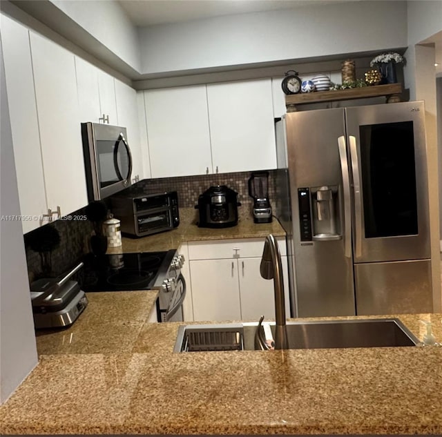 kitchen with white cabinetry, sink, and appliances with stainless steel finishes