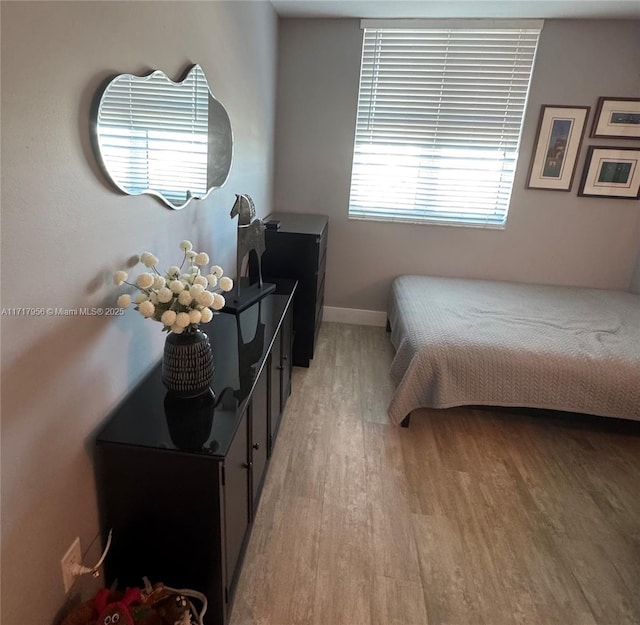 bedroom with light hardwood / wood-style floors