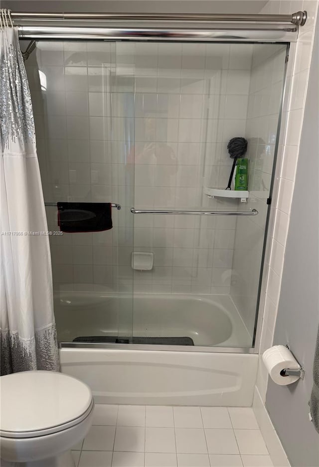 bathroom featuring toilet, shower / bath combination with curtain, and tile patterned floors