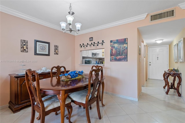 dining space featuring crown molding, light tile patterned floors, and an inviting chandelier