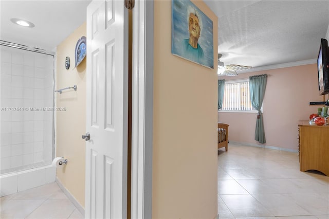 hall with light tile patterned flooring and ornamental molding