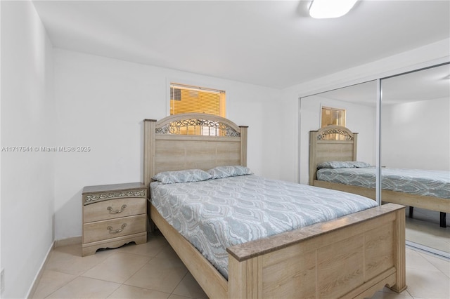 bedroom featuring a closet and light tile patterned flooring