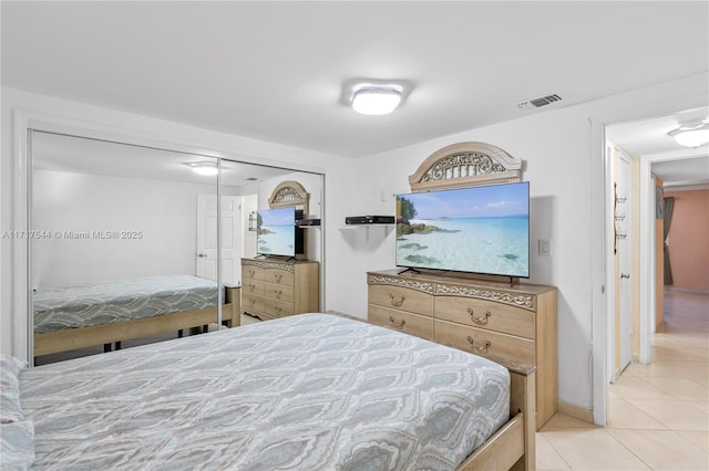 tiled bedroom with a closet