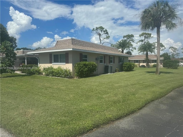 view of home's exterior with a yard and central AC unit