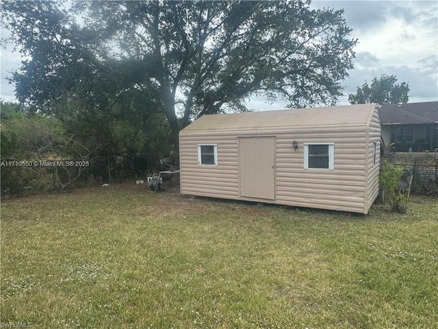 view of outbuilding featuring a yard