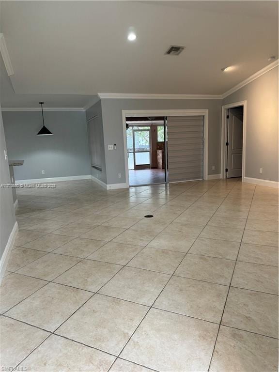 tiled spare room featuring ornamental molding