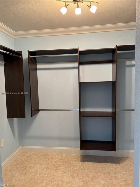 spacious closet with light tile patterned floors