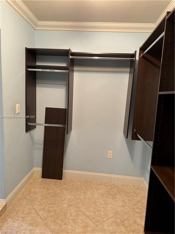 walk in closet with light tile patterned floors