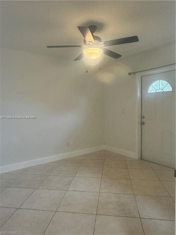 tiled foyer featuring ceiling fan