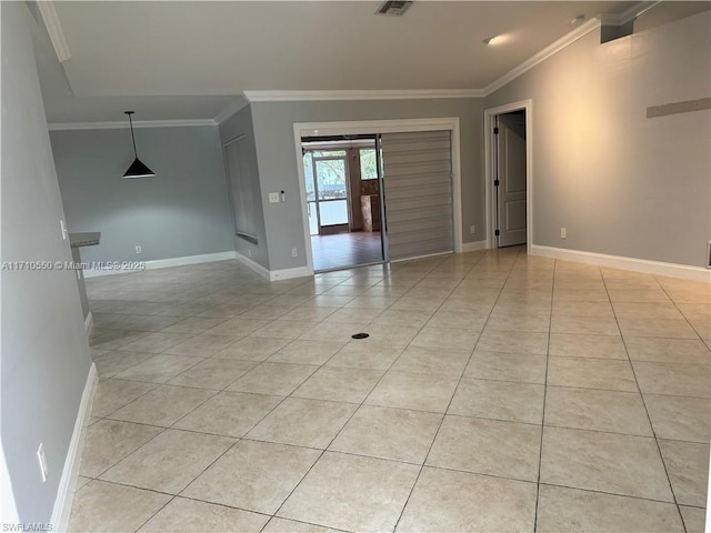 empty room featuring crown molding, french doors, and light tile patterned floors