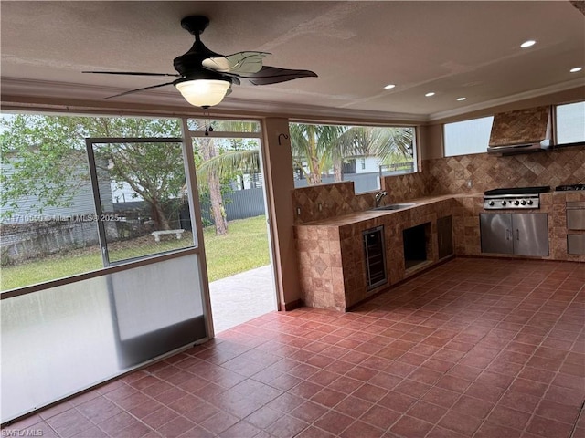 interior space featuring tile patterned floors, sink, beverage cooler, and plenty of natural light