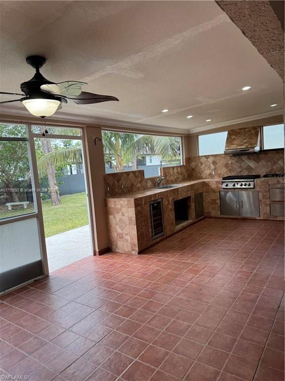 view of patio / terrace featuring wine cooler, ceiling fan, and an outdoor kitchen