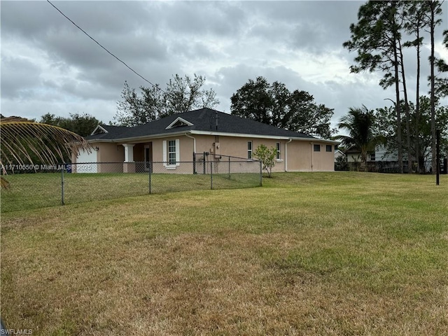 rear view of property with a lawn