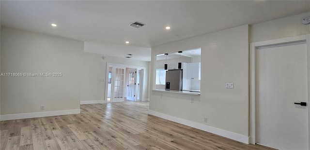 interior space featuring french doors and light wood-type flooring