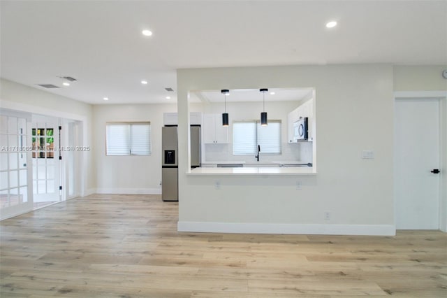 interior space with sink and light hardwood / wood-style flooring