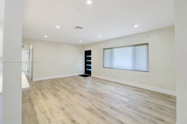 unfurnished room with light hardwood / wood-style floors