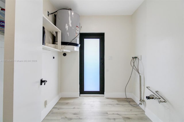 interior space featuring washer hookup and light hardwood / wood-style flooring