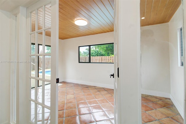 interior space with wooden ceiling and light tile patterned floors