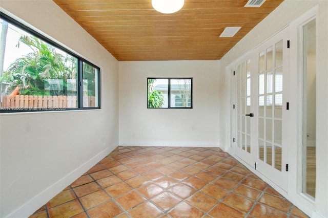 unfurnished sunroom featuring lofted ceiling and wood ceiling